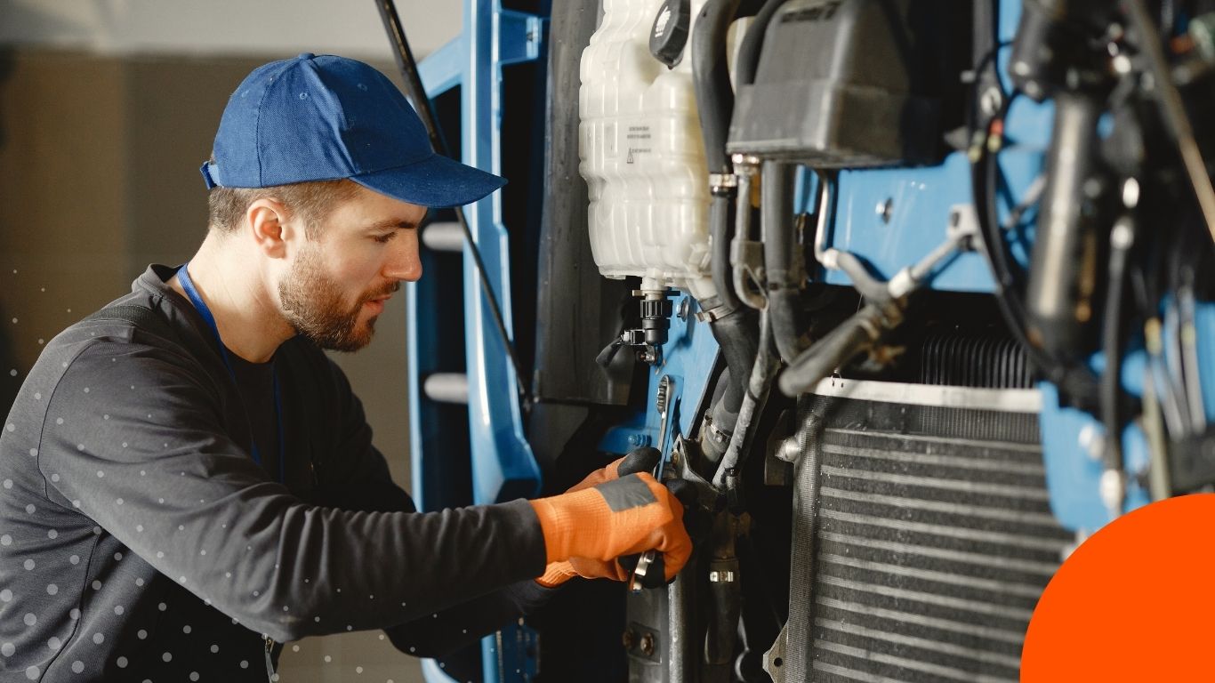 A technician servicing agricultural machinery in a workshop