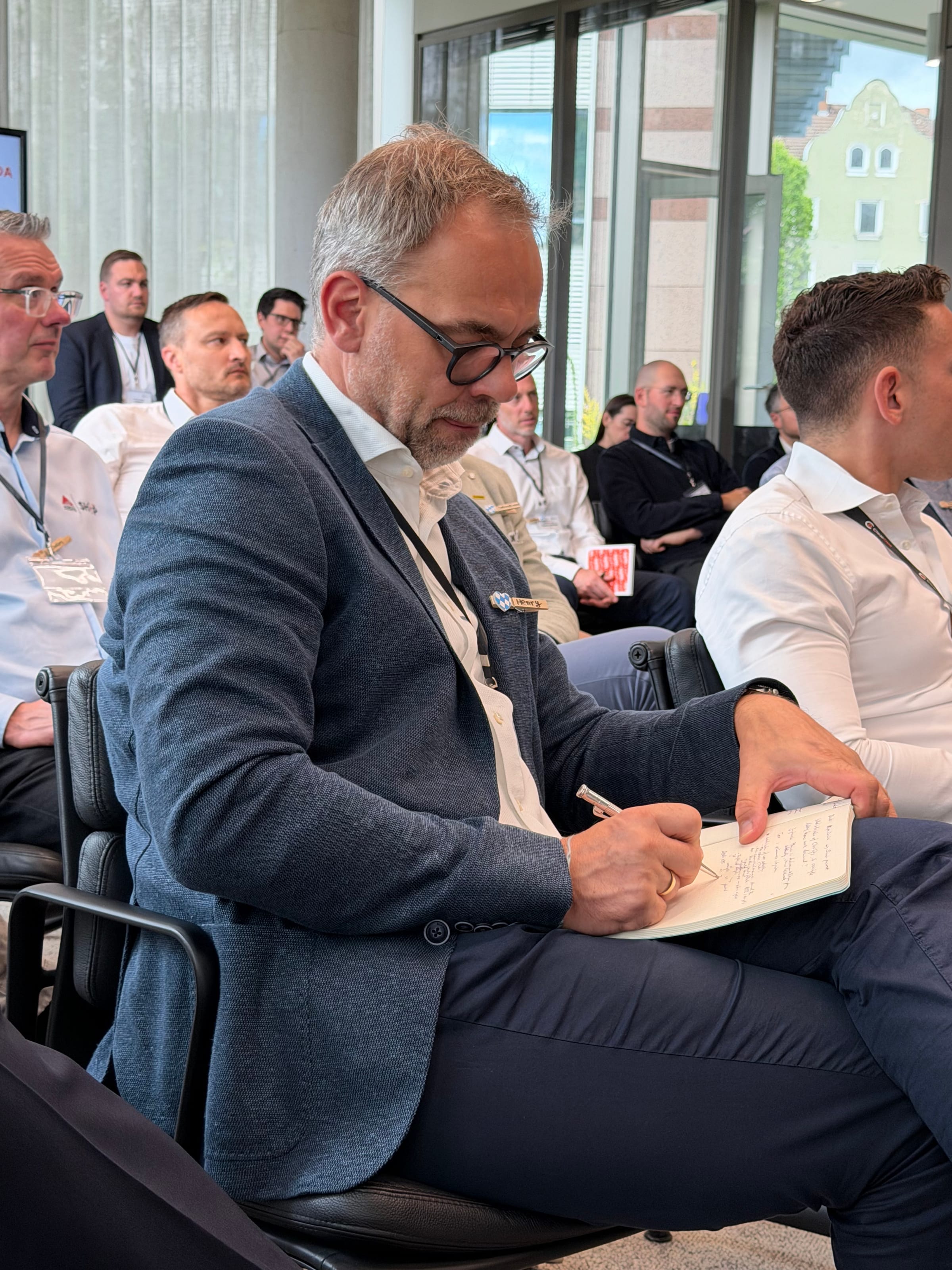 Attendee taking notes during a forum session