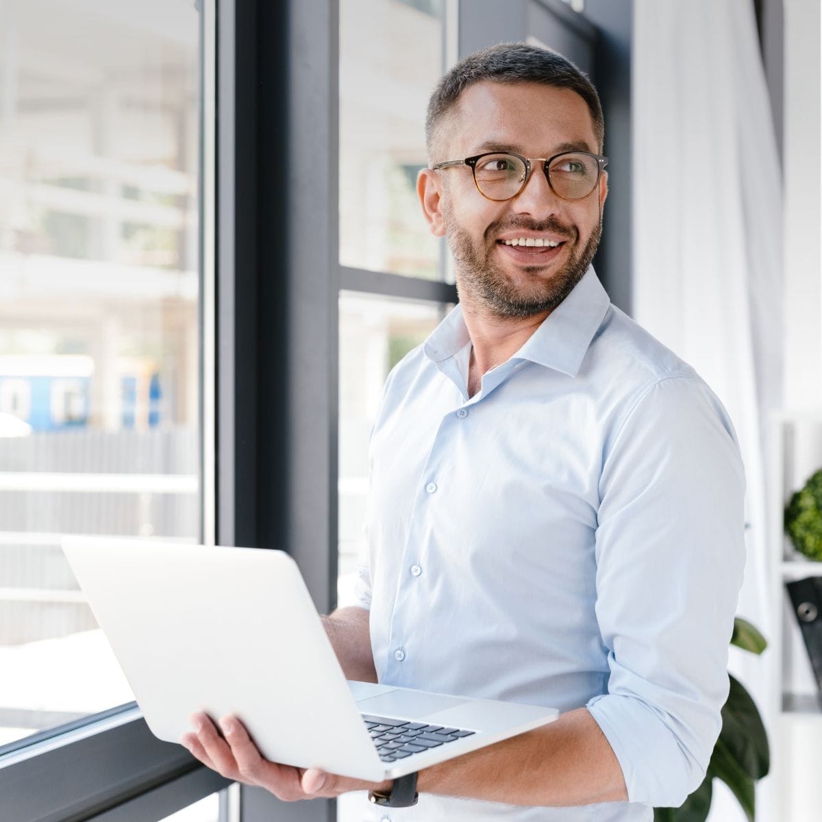 Planner holding a laptop next to a window